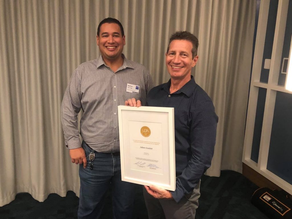 Adam Gowlett receives UDIA Distinguished Service Award from fellow board member Nathan Lee Long