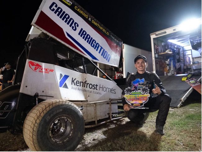 Ash Ewing beside his racecar