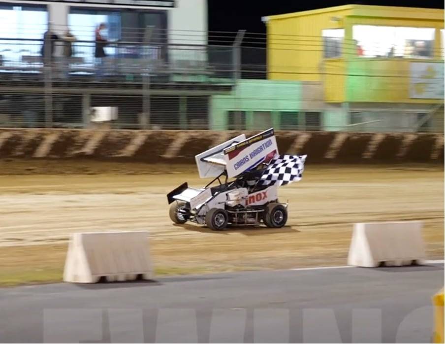 Ash driving with checkered flag