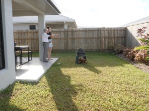 Barry talking with a client in the backyard