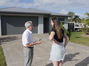 Barry talking with a client at the front of a David McCoy House