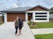 A young couple out the front of their Kenfrost Home purchase