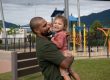 Jayden holding his daughter at the park