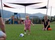 A mum watches toddler playing with a soccer ball at Mamu Link Park Mt Peter