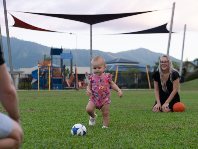 KFH_Fam_MtPeter-18 A mum watches toddler playing with a soccer ball at Mamu Link Park Mt Peter