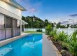 pool built next to a retaining wall home in cairns